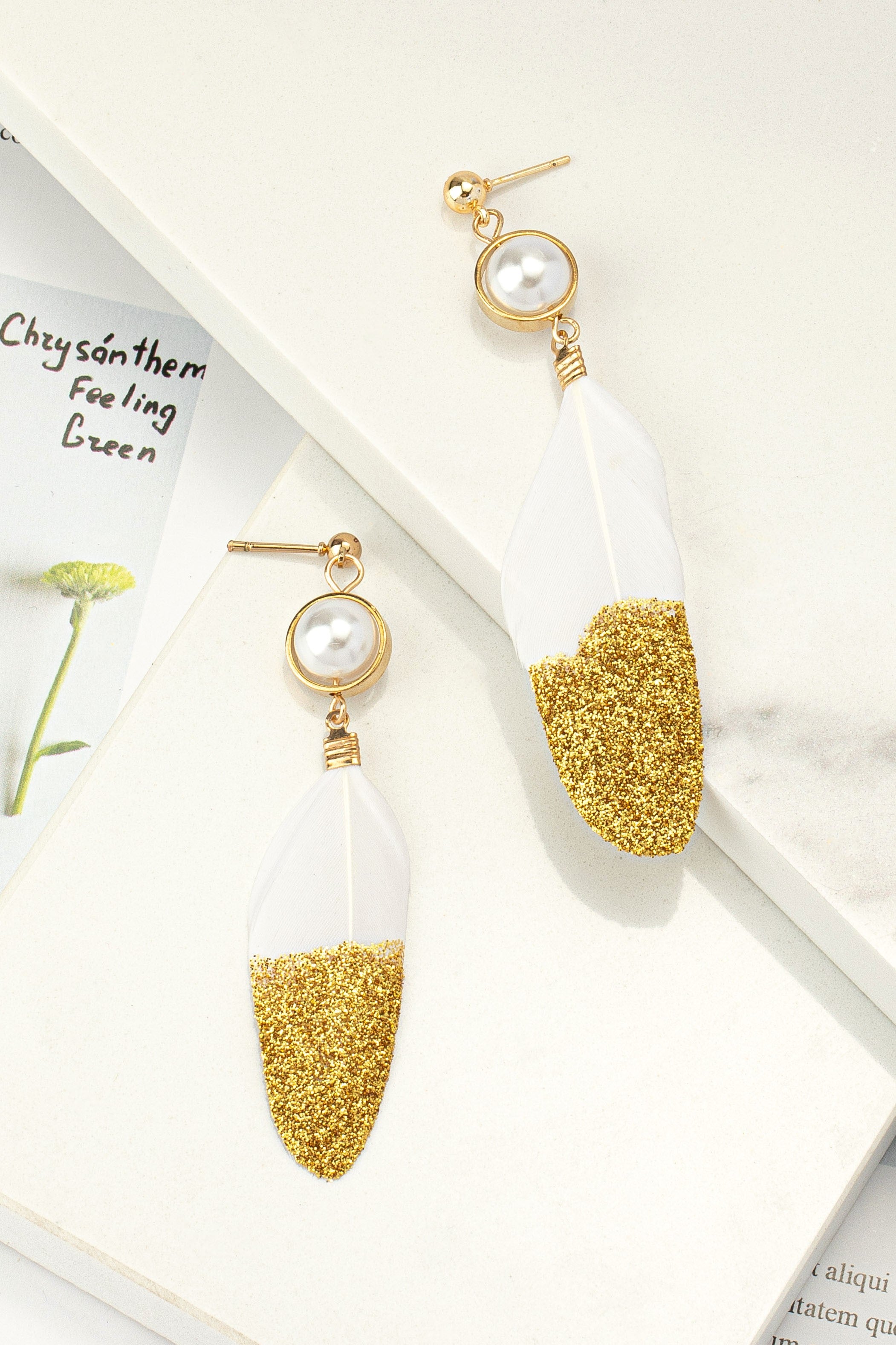 Gold dipped feather and pearl drop earrings