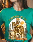 Something in the Orange Cowgirl Graphic Tee